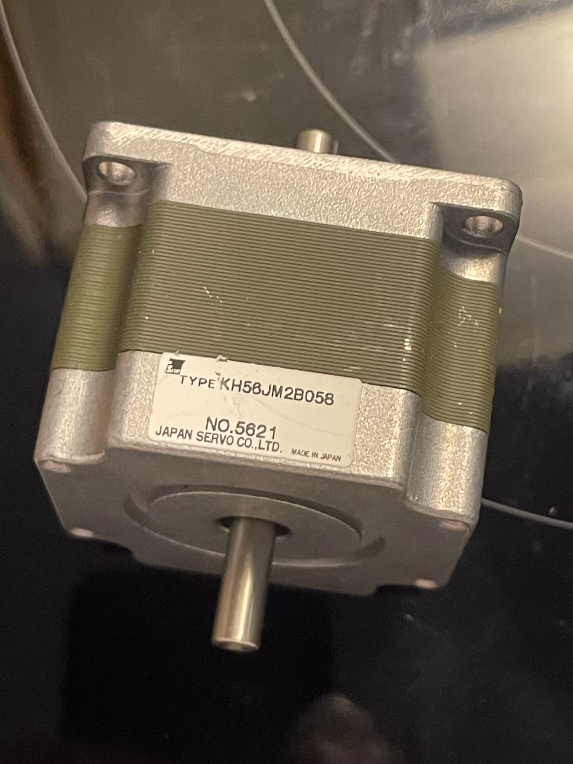 Stepper motor nameplate reading TYPE KH56JM2B058, NO.5621, JAPAN SERVO CO.,LTD., MADE IN JAPAN, plain round shaft