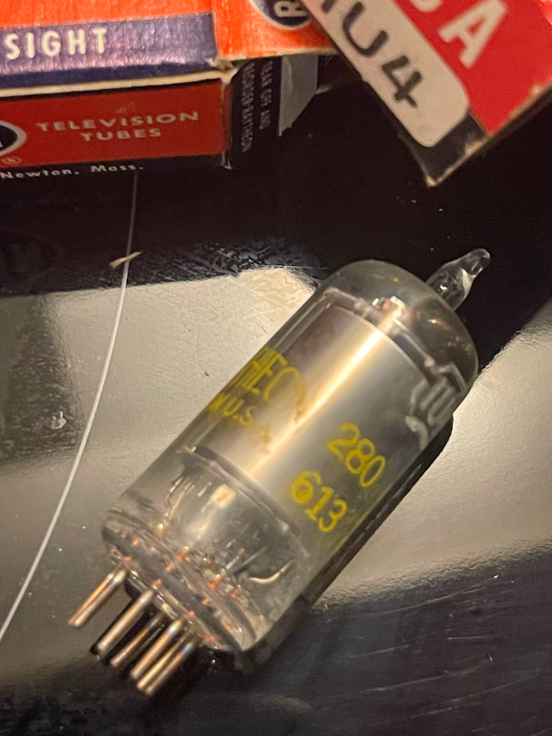 Seven pin miniature tube with yellow glass markings 280 and 613, RCA 1U4 carton and Raytheon box behind