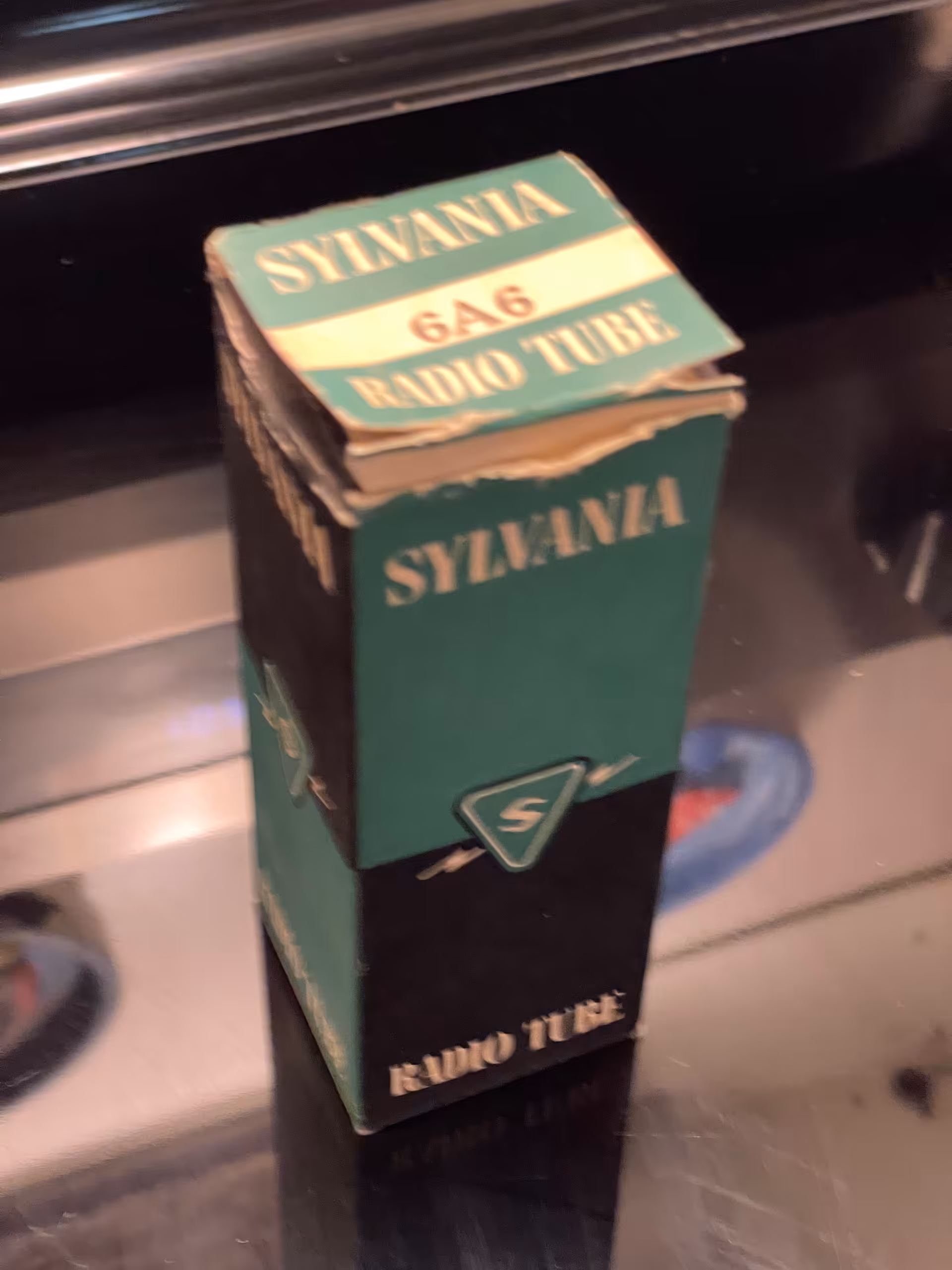 Teal and black Sylvania carton standing upright, top panel reads 6A6 RADIO TUBE, S in triangle logo on side.