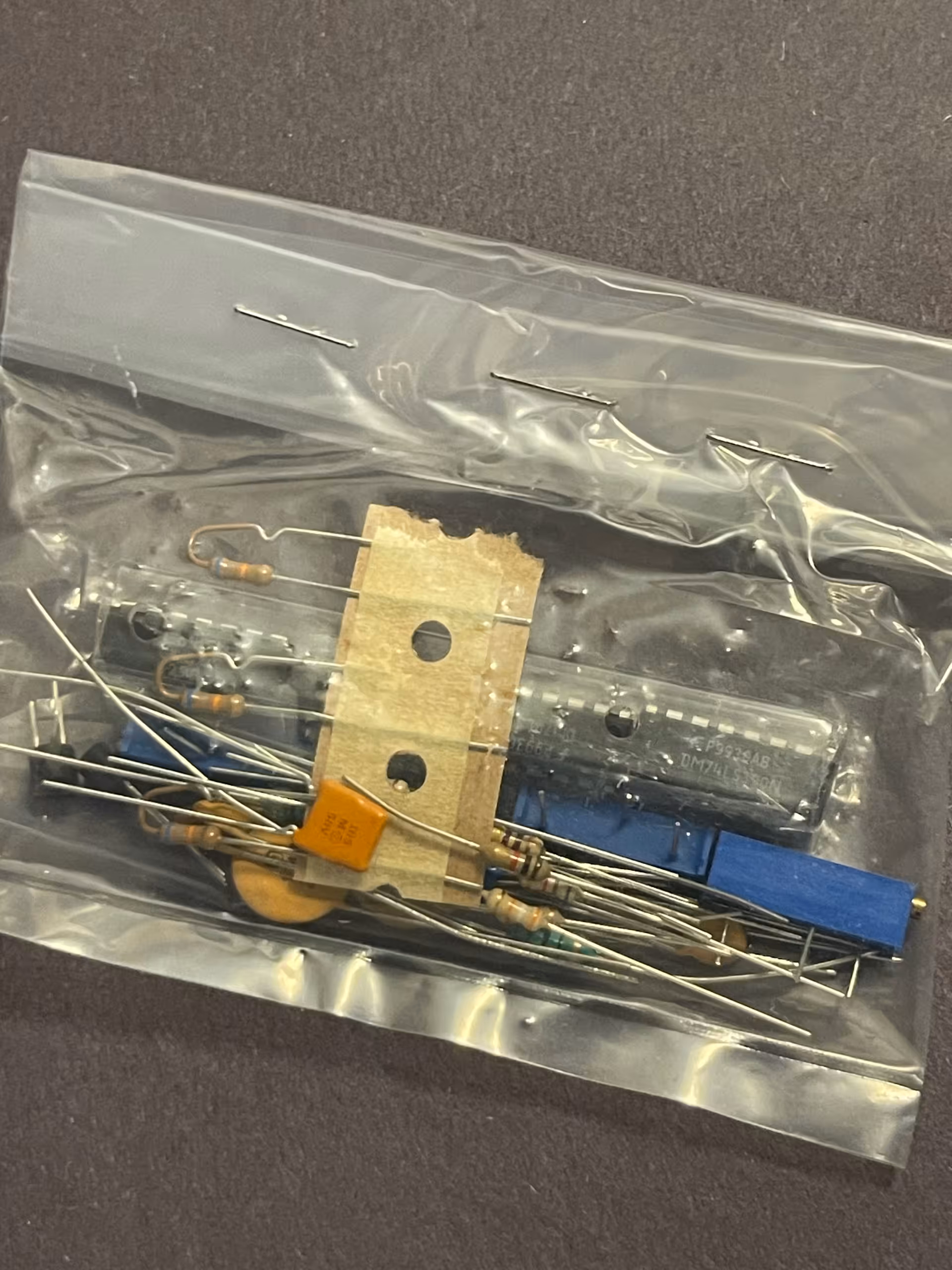 Sealed antistatic bag of loose parts, DIP marked DM74LS390N with date code P9939AB, blue trimpots, resistors.
