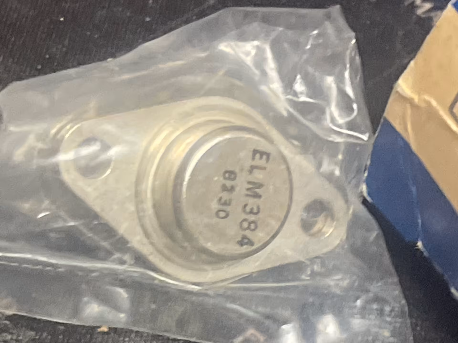 Elm Semiconductor ELM384 power transistor in a metal flange package with two mounting holes